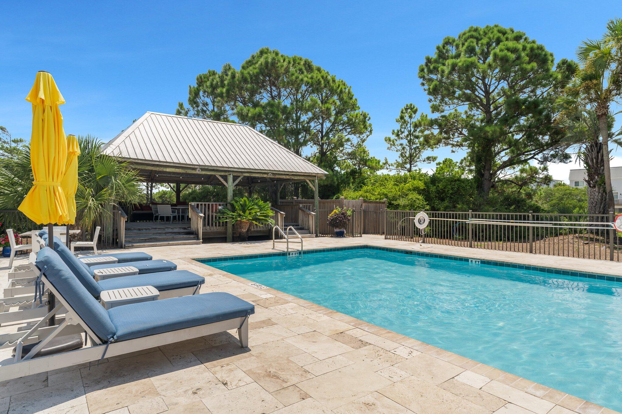 145 Beachfront Trail, Unit 302 Santa Rosa Beach, FL 32459 - Photo 24 of 42 a view of a backyard with couches plants and large tree