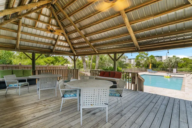a view of a patio with wooden floor a yard tables and chairs