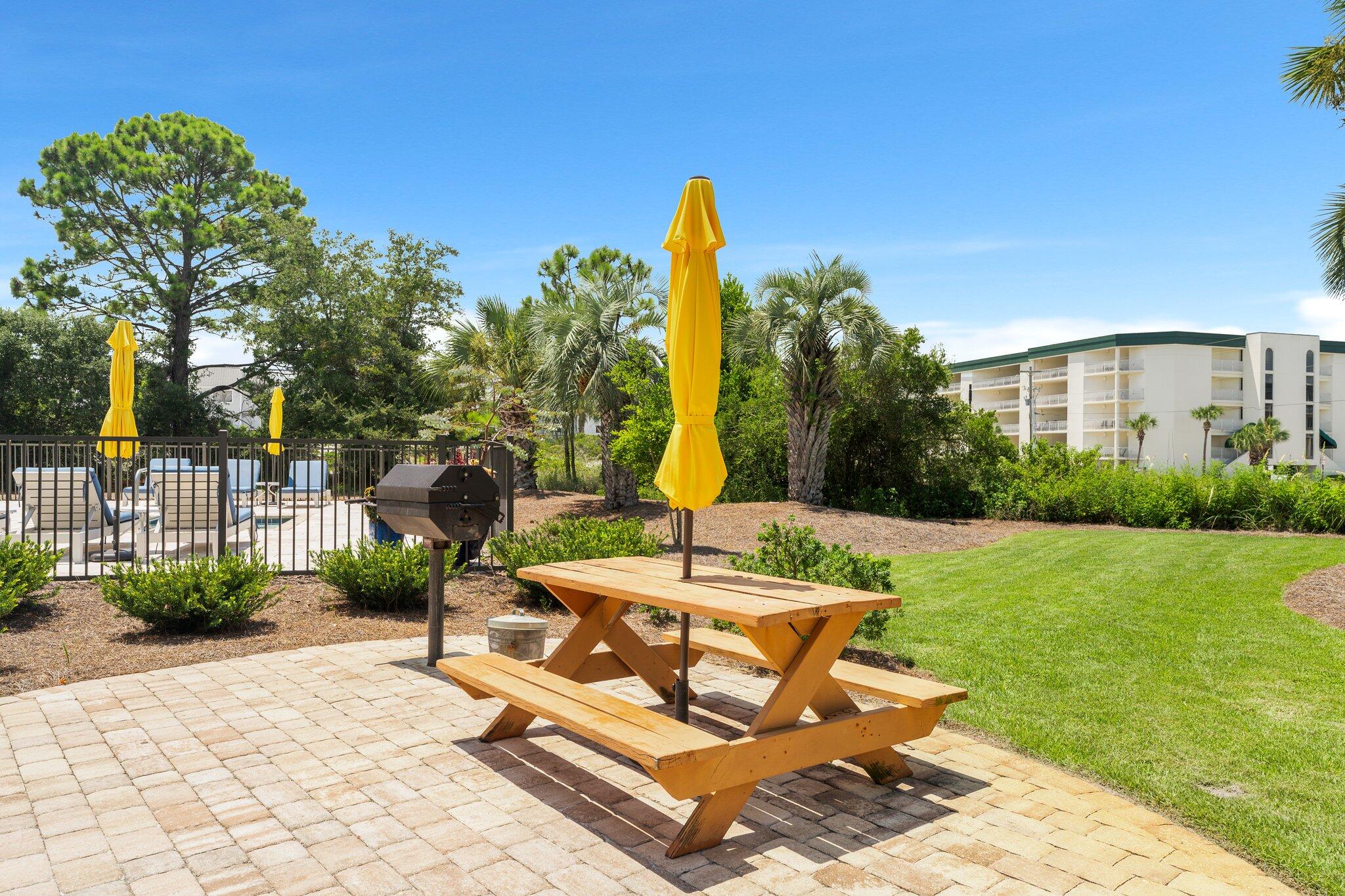 145 Beachfront Trail, Unit 302 Santa Rosa Beach, FL 32459 - Photo 31 of 42 a view of a backyard with plants and a patio