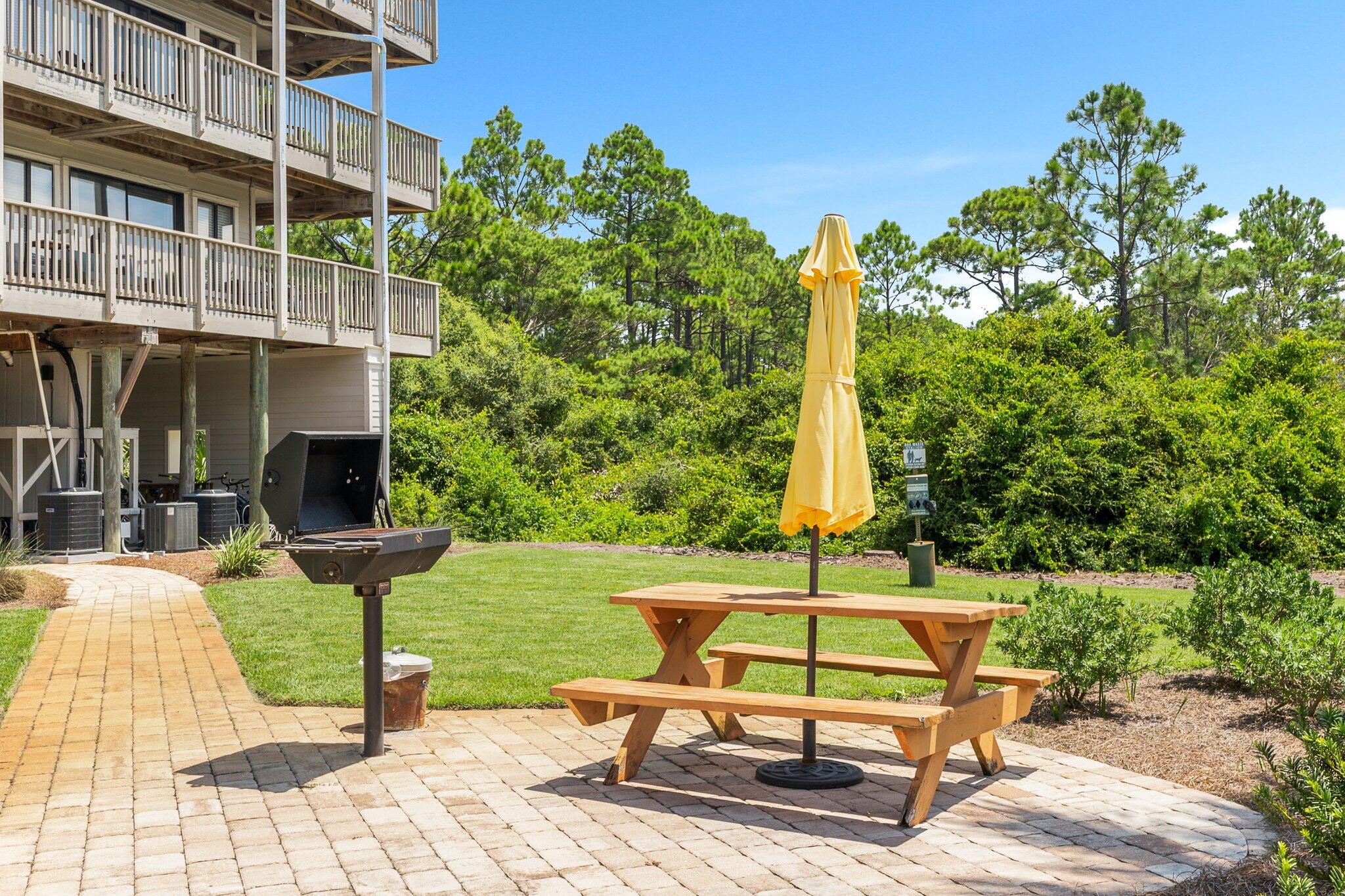 145 Beachfront Trail, Unit 302 Santa Rosa Beach, FL 32459 - Photo 32 of 42 a bench is sitting in front of a building