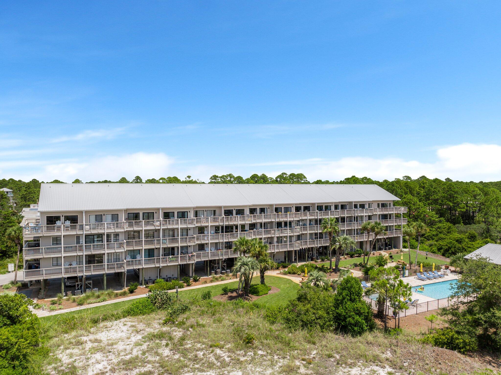 145 Beachfront Trail, Unit 302 Santa Rosa Beach, FL 32459 - Photo 33 of 42 a view of a large building with a big yard