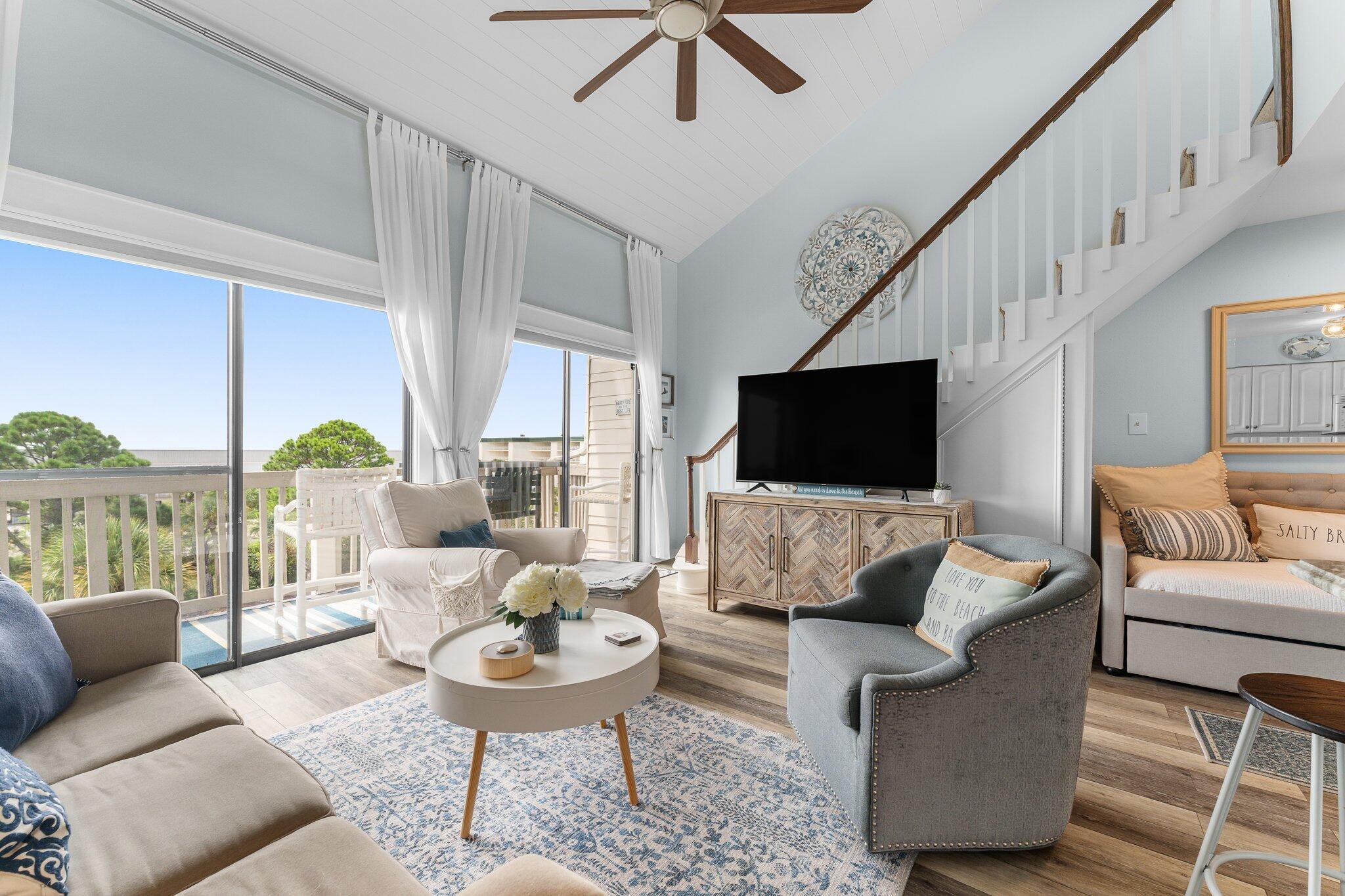 145 Beachfront Trail, Unit 302 Santa Rosa Beach, FL 32459 - Photo 4 of 42 a living room with furniture and a flat screen tv
