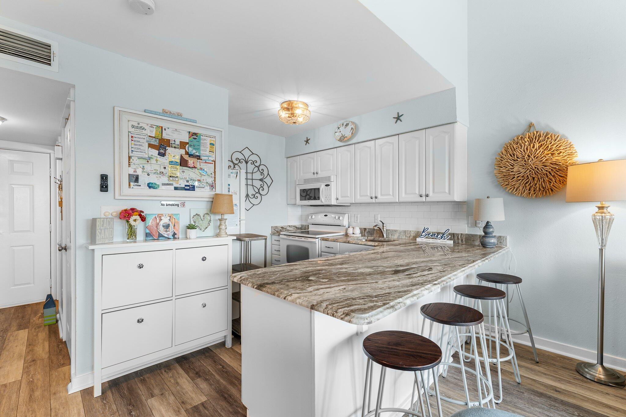 145 Beachfront Trail, Unit 302 Santa Rosa Beach, FL 32459 - Photo 10 of 42 a kitchen with stainless steel appliances granite countertop a sink and cabinets