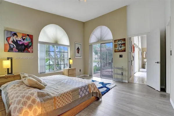 a bedroom with a large bed and a chandelier