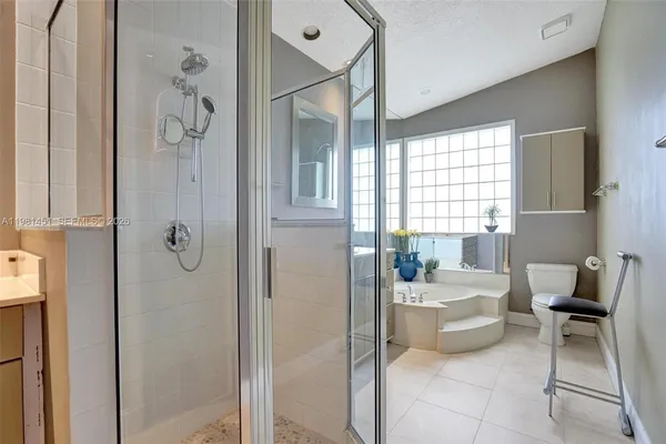 a bathroom with a tub mirror and window