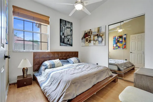 a bedroom with a bed and wooden floor