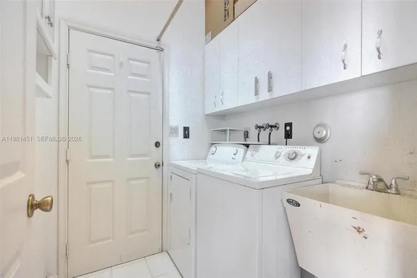 a utility room with cabinets