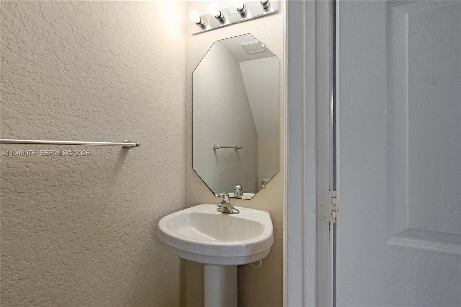3533 Sonoma Drive Riviera Beach, FL 33404 - Photo 11 of 34 a bathroom with a sink a mirror and a shower