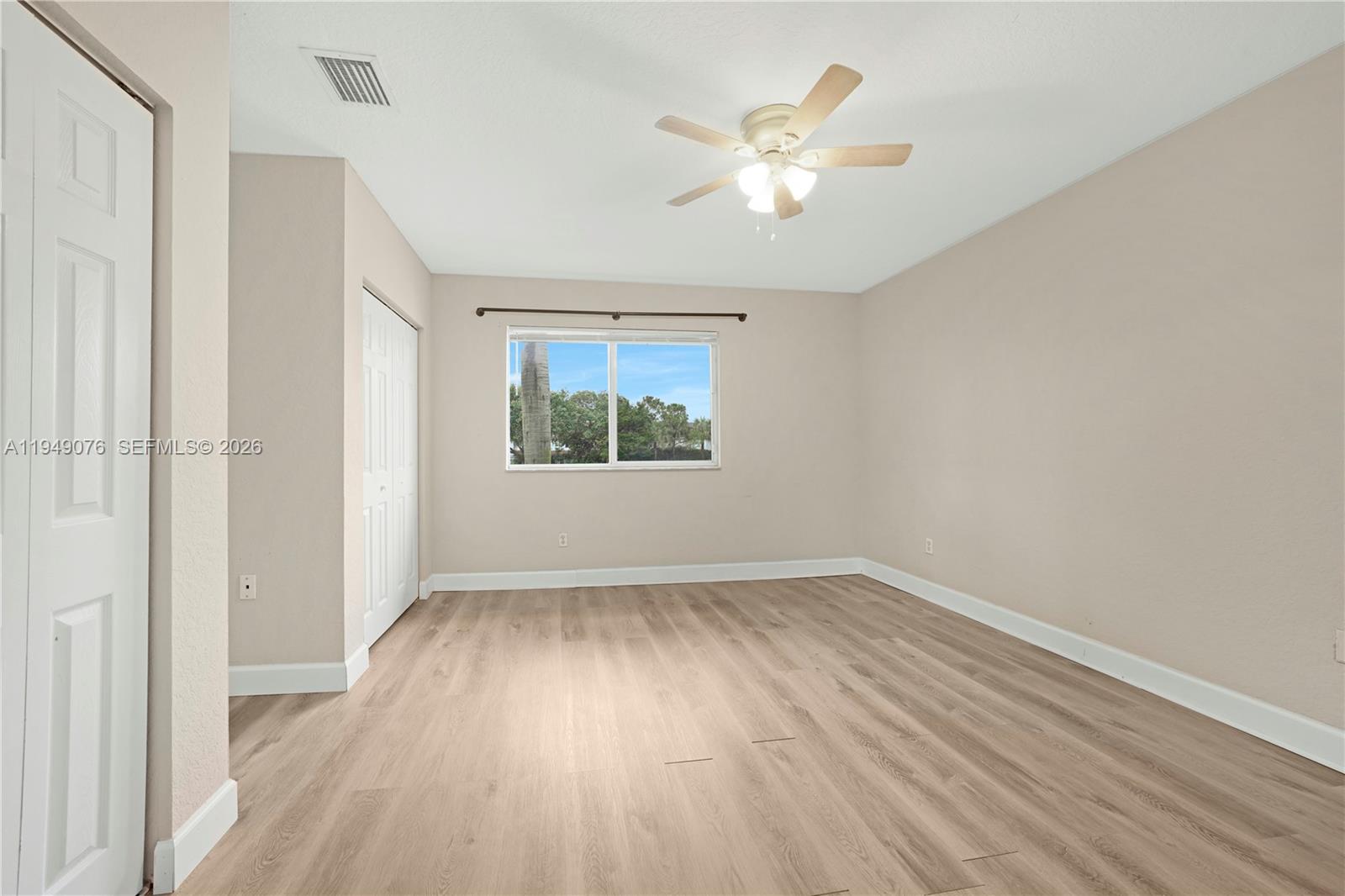 3533 Sonoma Drive Riviera Beach, FL 33404 - Photo 13 of 34 wooden floor in an empty room with a window