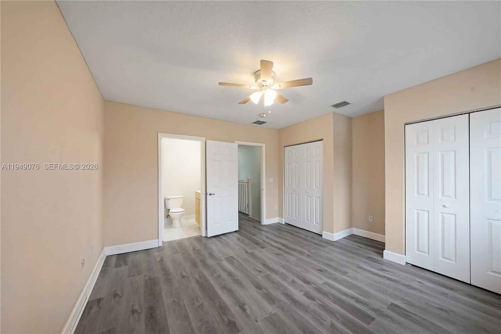 3533 Sonoma Drive Riviera Beach, FL 33404 - Photo 15 of 34 an empty room with wooden floor and windows