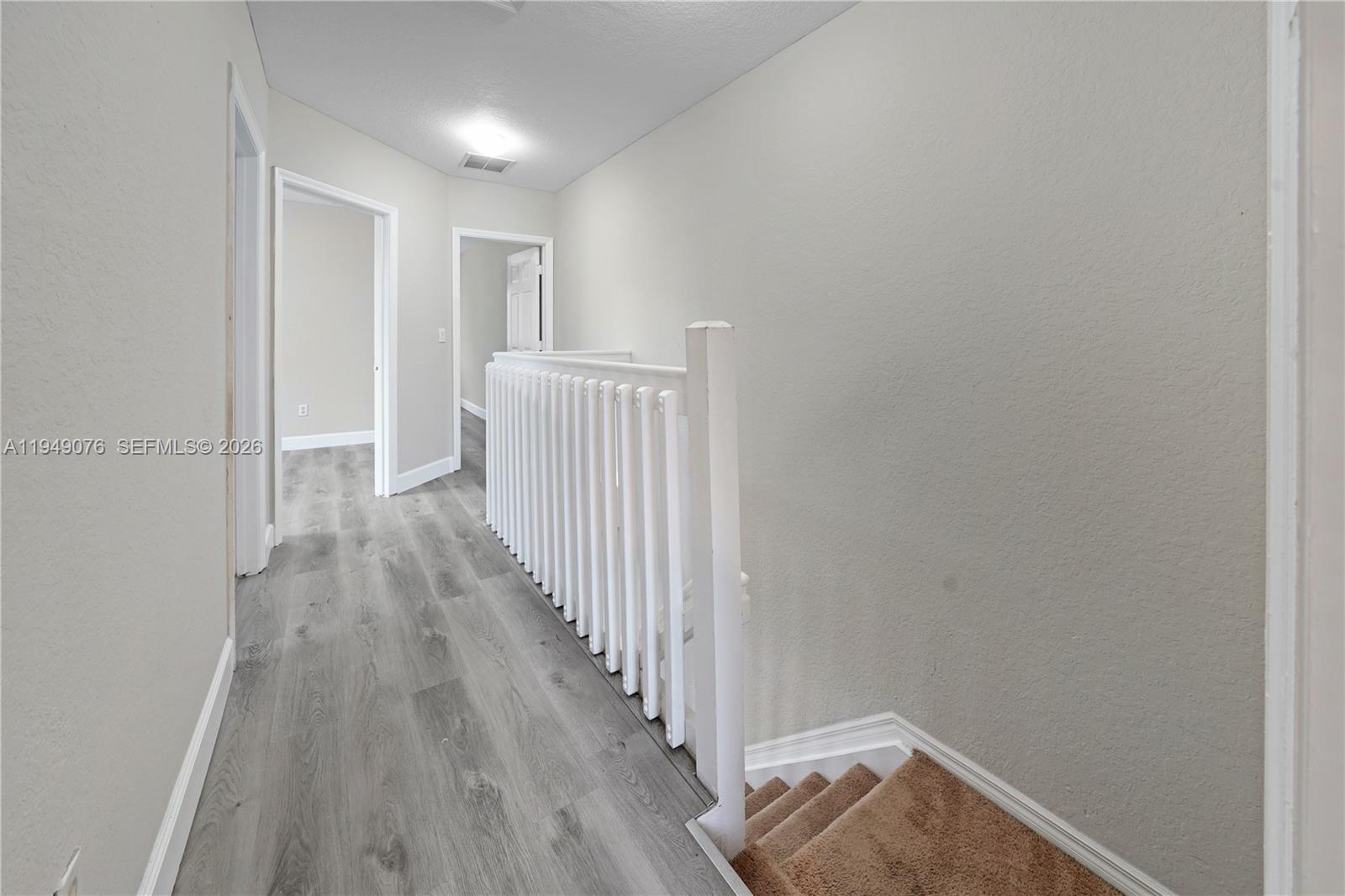 3533 Sonoma Drive Riviera Beach, FL 33404 - Photo 19 of 34 a view of a hallway with wooden floor