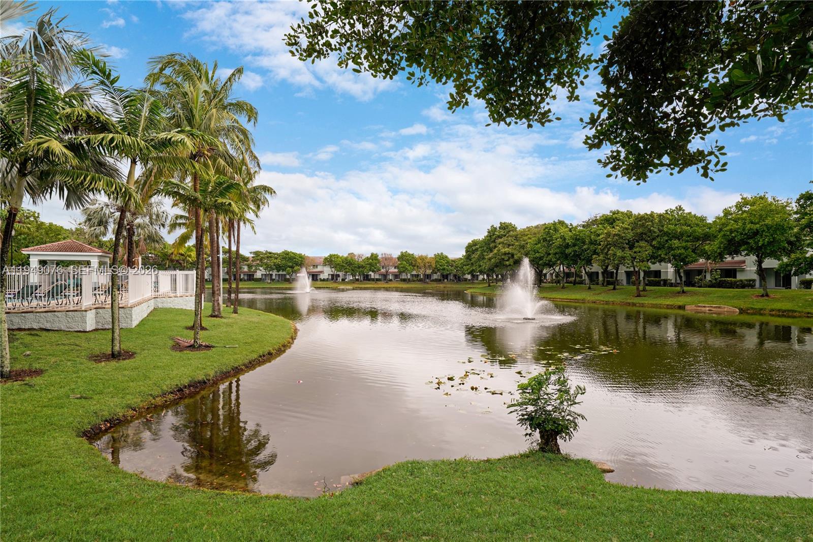 3533 Sonoma Drive Riviera Beach, FL 33404 - Photo 29 of 34 a view of a lake with a garden and trees