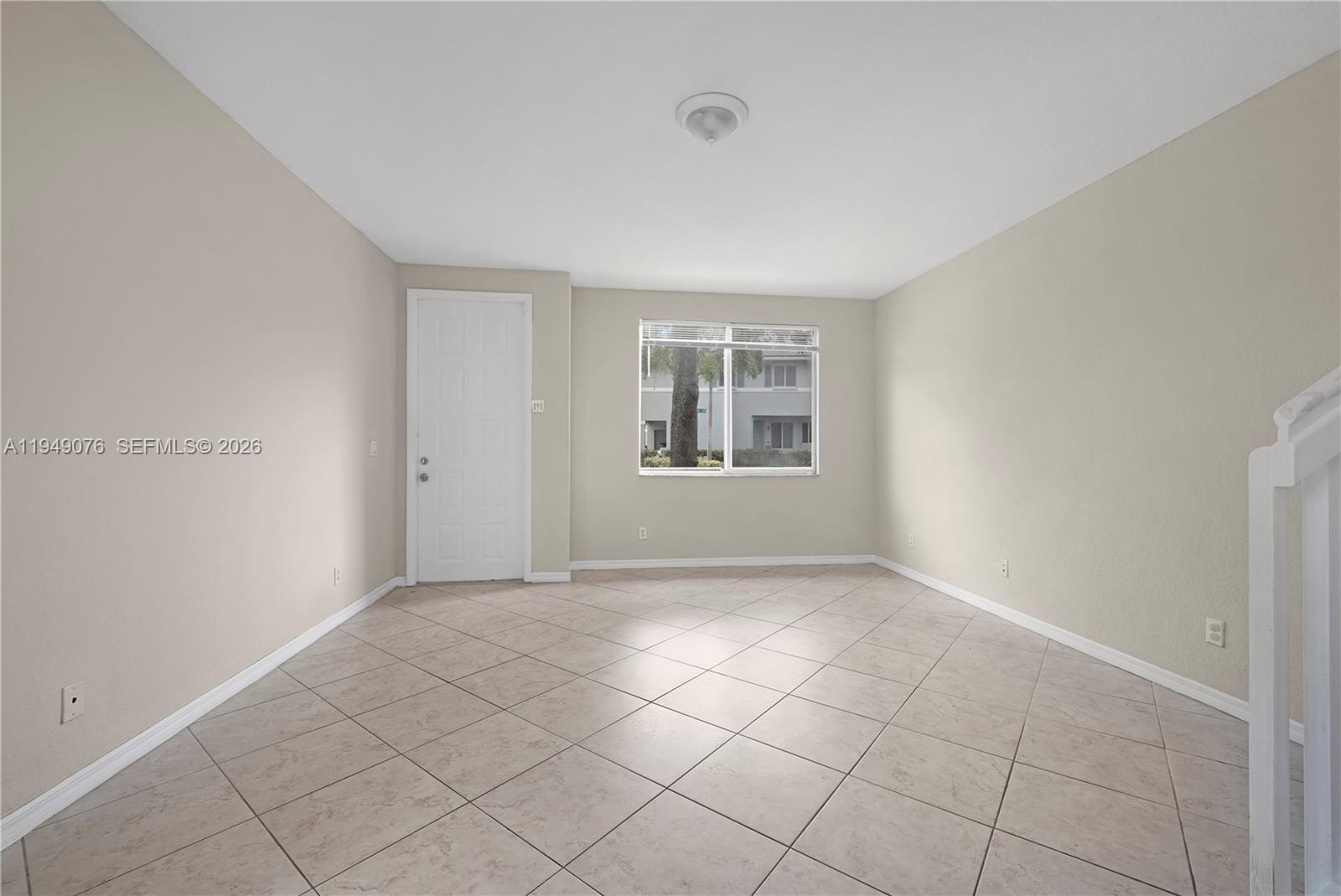 3533 Sonoma Drive Riviera Beach, FL 33404 - Photo 3 of 34 a view of an empty room with window and chandelier fan