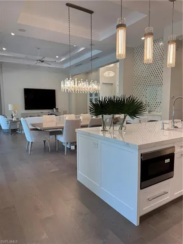 a living room with stainless steel appliances kitchen island furniture and a view of kitchen