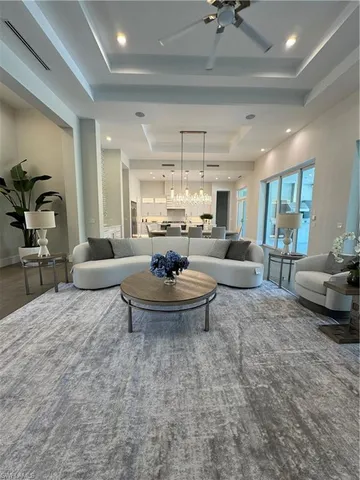 a living room with furniture and a chandelier