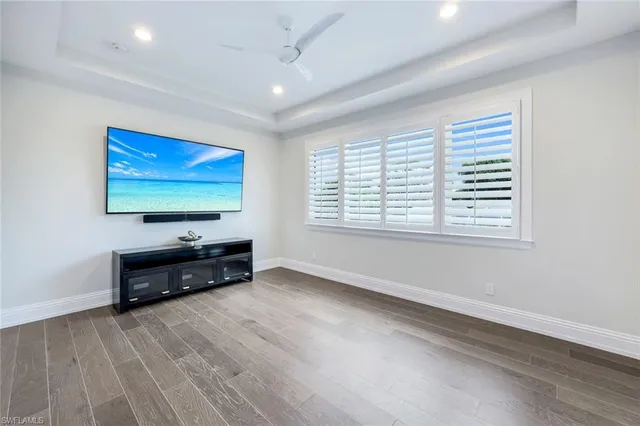 wooden floor chandelier and windows in a room
