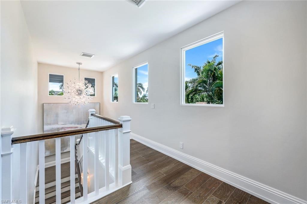569 Neapolitan Way Naples, FL 34103 - Photo 24 of 50 a view of entryway with wooden floor and stairs