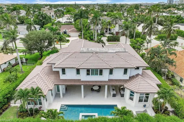 an aerial view of a house with a yard balcony and outdoor seating
