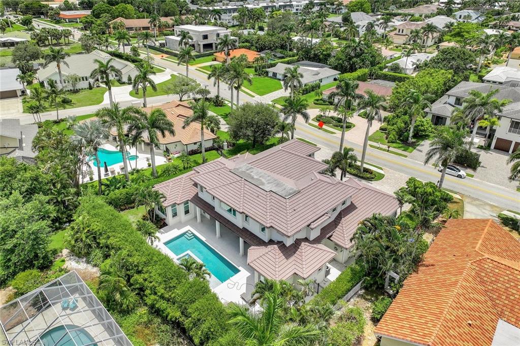 569 Neapolitan Way Naples, FL 34103 - Photo 44 of 50 an aerial view of a house with a garden