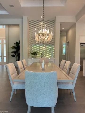 a view of a dining room with furniture and chandelier
