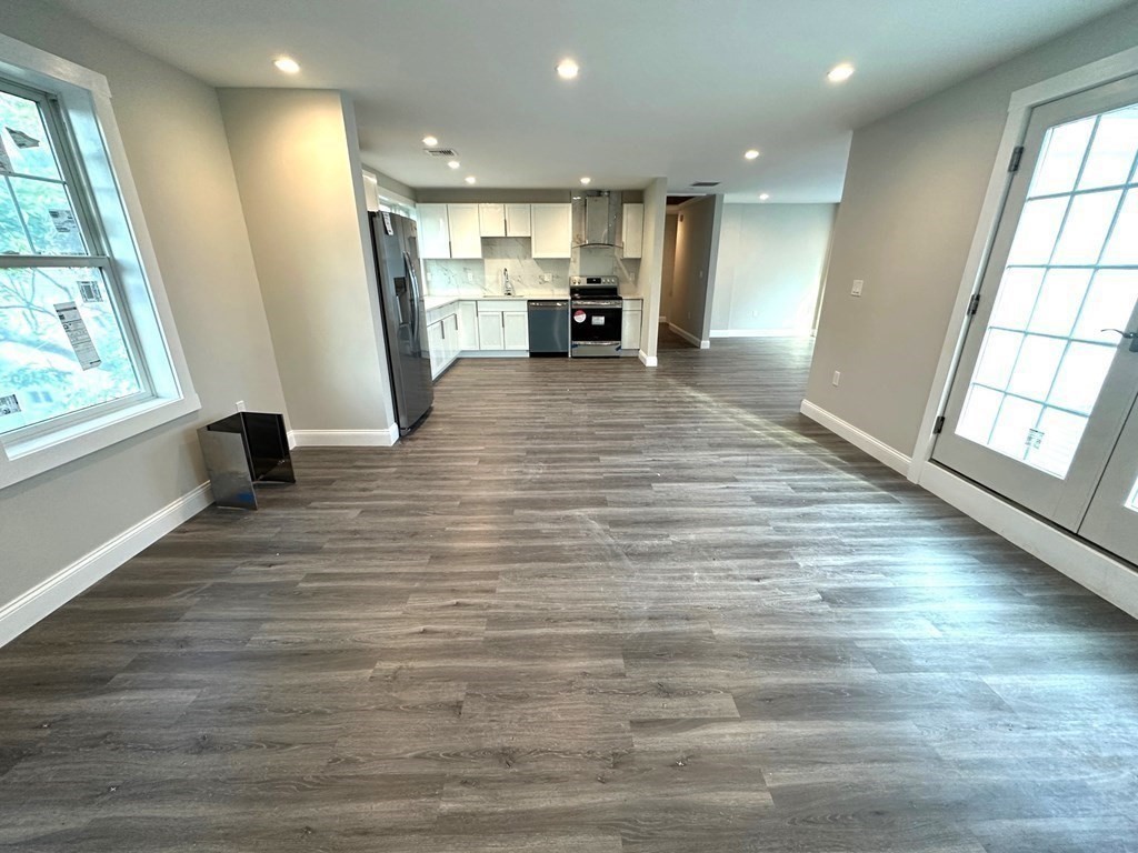a view of kitchen with cabinets and wooden floor
