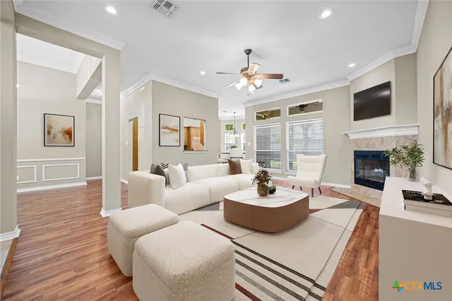 a living room with furniture a fireplace and a flat screen tv
