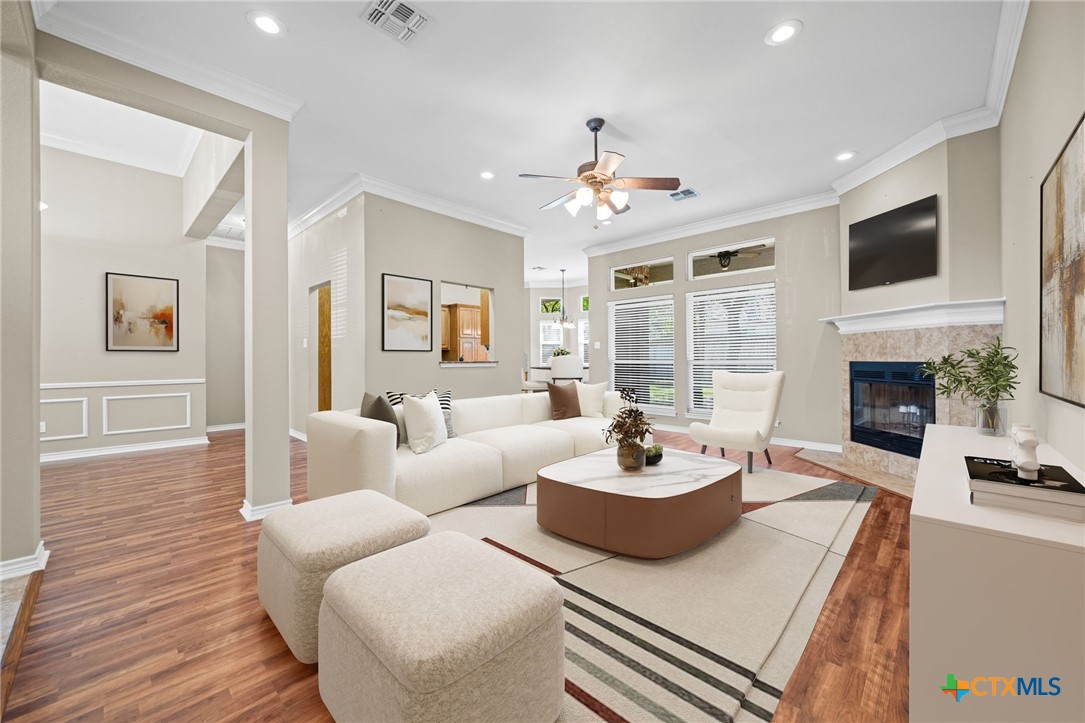 a living room with furniture a fireplace and a flat screen tv