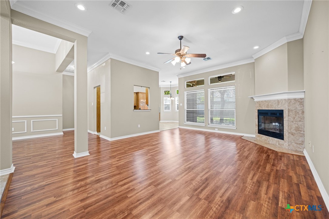 2807 Amber Forest Trail Belton, TX 76513 - Photo 11 of 40 a view of an empty room with wooden floor and a window