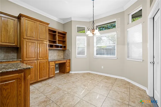 a kitchen with stainless steel appliances granite countertop a stove and a refrigerator