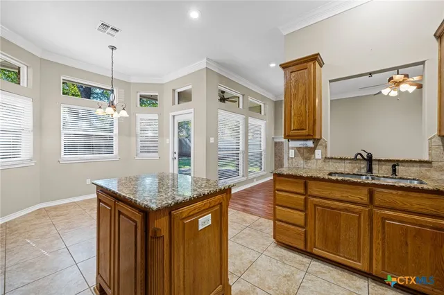 a bathroom with granite countertop a sink and a mirror
