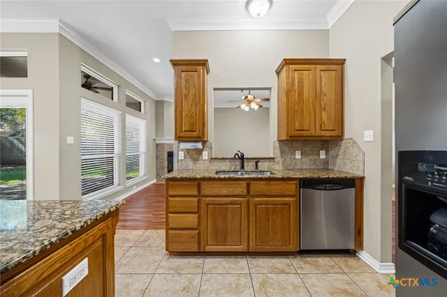 a kitchen with a sink stove and cabinets