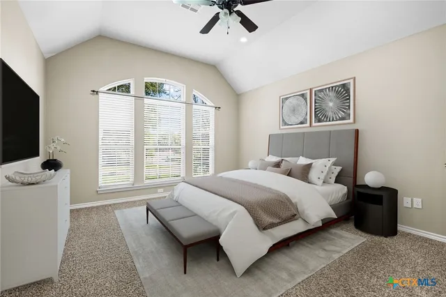 a bedroom with a bed and a television