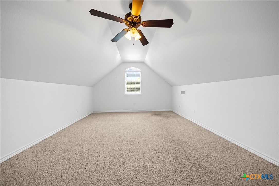 2807 Amber Forest Trail Belton, TX 76513 - Photo 36 of 40 an empty room with a chandelier fan and windows