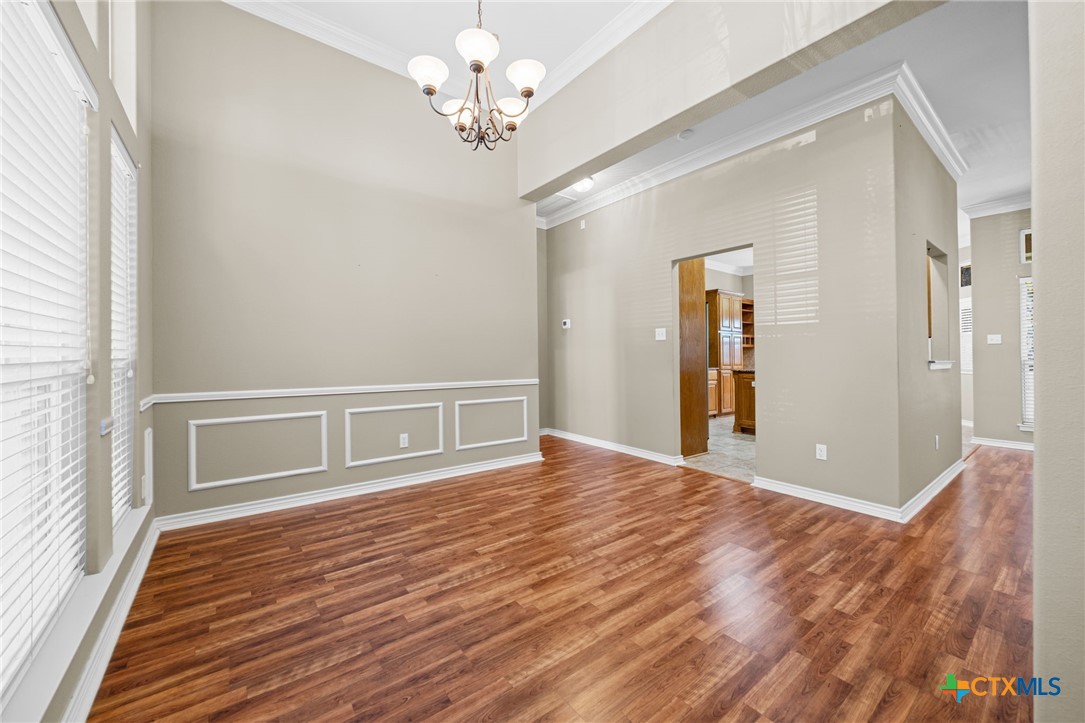 2807 Amber Forest Trail Belton, TX 76513 - Photo 8 of 40 a view of an empty room with a window and wooden floor