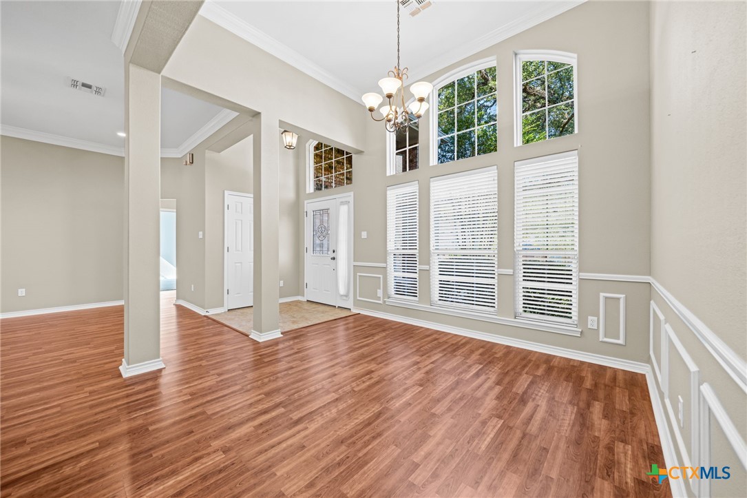 2807 Amber Forest Trail Belton, TX 76513 - Photo 9 of 40 a view of an empty room with wooden floor chandeliers