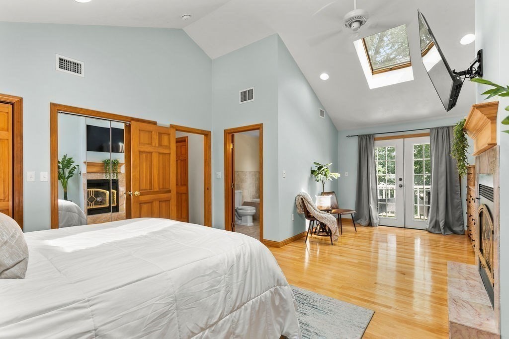 11 Amherst Road Stoughton, MA 02072 - Photo 11 of 42 a bedroom with a large bed a table and painting on the wall