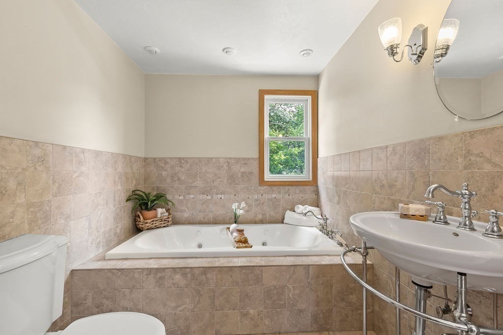 11 Amherst Road Stoughton, MA 02072 - Photo 13 of 42 a bath tub sitting next to a white sink