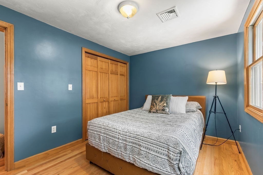 11 Amherst Road Stoughton, MA 02072 - Photo 17 of 42 a bedroom with a bed and lamp