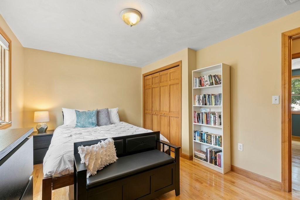 11 Amherst Road Stoughton, MA 02072 - Photo 19 of 42 a bedroom with a bed and a book shelf