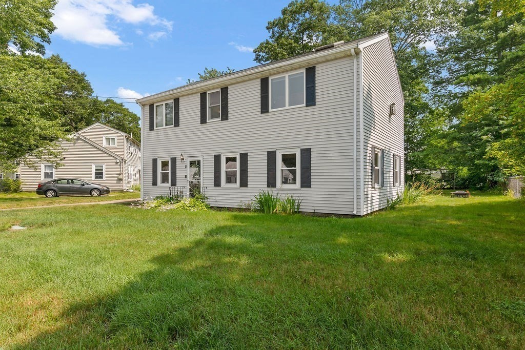 11 Amherst Road Stoughton, MA 02072 - Photo 2 of 42 a view of a white house with a big yard potted plants and large tree