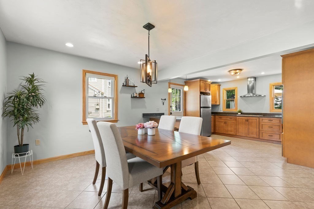 11 Amherst Road Stoughton, MA 02072 - Photo 23 of 42 a view of a dining room and livingroom with furniture wooden floor a chandelier