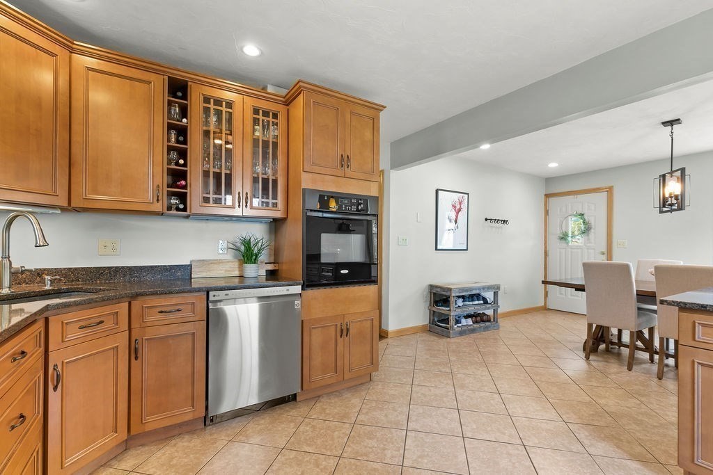 11 Amherst Road Stoughton, MA 02072 - Photo 25 of 42 a kitchen with stainless steel appliances granite countertop a stove and cabinets