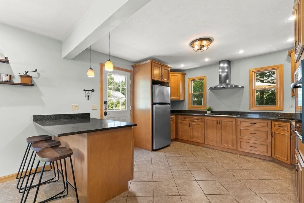 11 Amherst Road Stoughton, MA 02072 - Photo 26 of 42 a kitchen with stainless steel appliances granite countertop a sink and a refrigerator