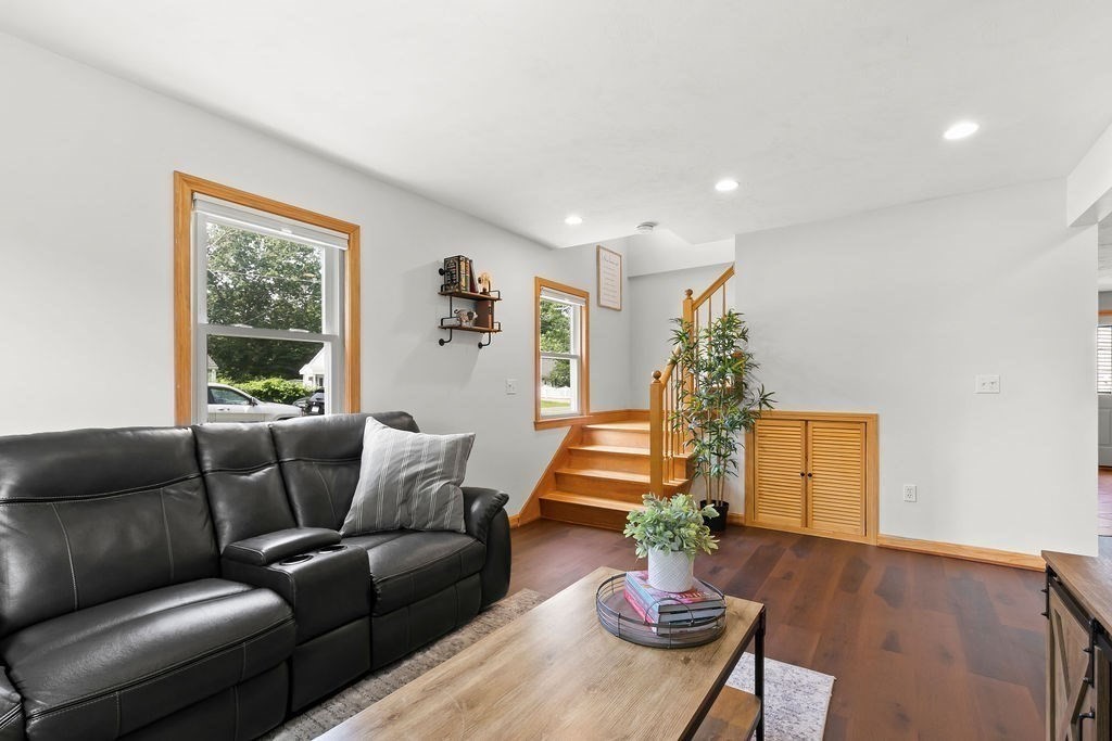 11 Amherst Road Stoughton, MA 02072 - Photo 32 of 42 a living room with furniture and a wooden floor