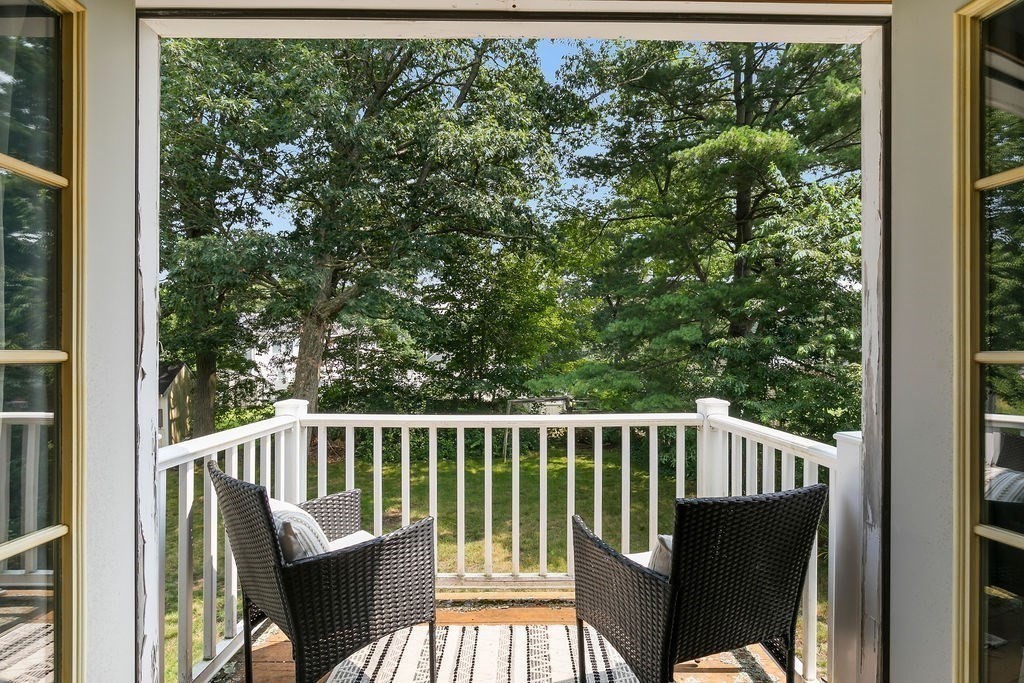 11 Amherst Road Stoughton, MA 02072 - Photo 7 of 42 a view of a chair and table in the balcony