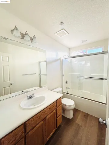 a bathroom with a double vanity sink toilet and a mirror
