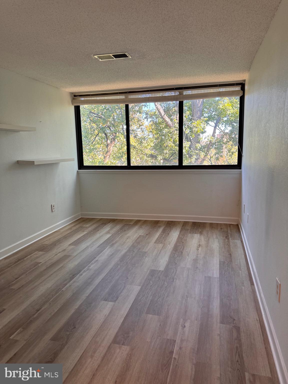 4 South Van Dorn Street, Unit 503 Alexandria, VA 22304 - Photo 20 of 21 wooden floor in an empty room with a window