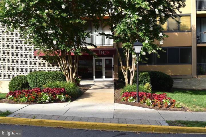 4 South Van Dorn Street, Unit 503 Alexandria, VA 22304 - Photo 2 of 21 a front view of a house with a garden and fountain in middle