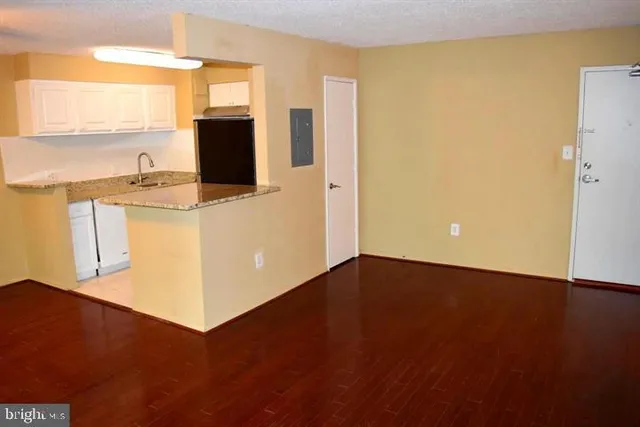 a view of a kitchen with wooden floor and a sink