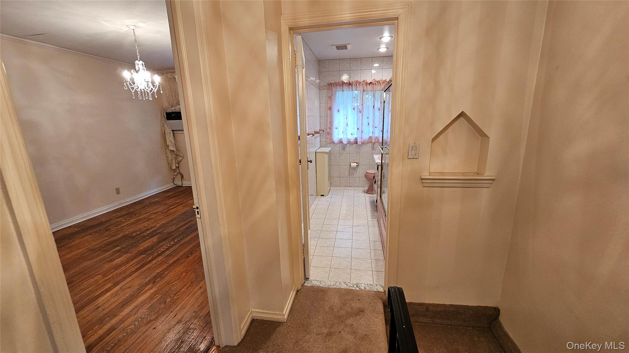 108-11 65th Road Queens, NY 11375 - Photo 17 of 22 Hall featuring a chandelier and wood finished floors